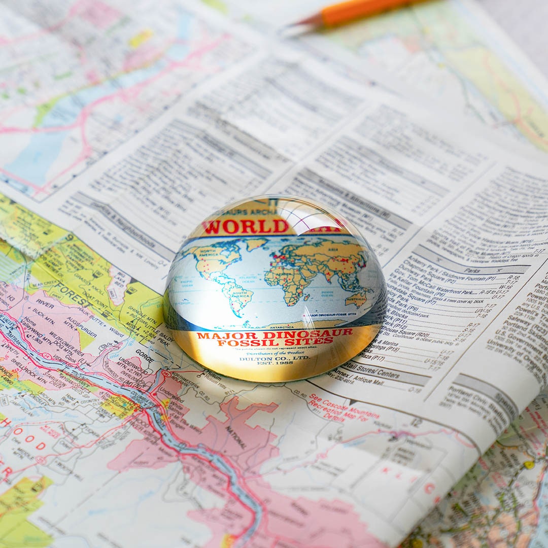 GLASS PAPERWEIGHT DINOSAUR WORLD MAP